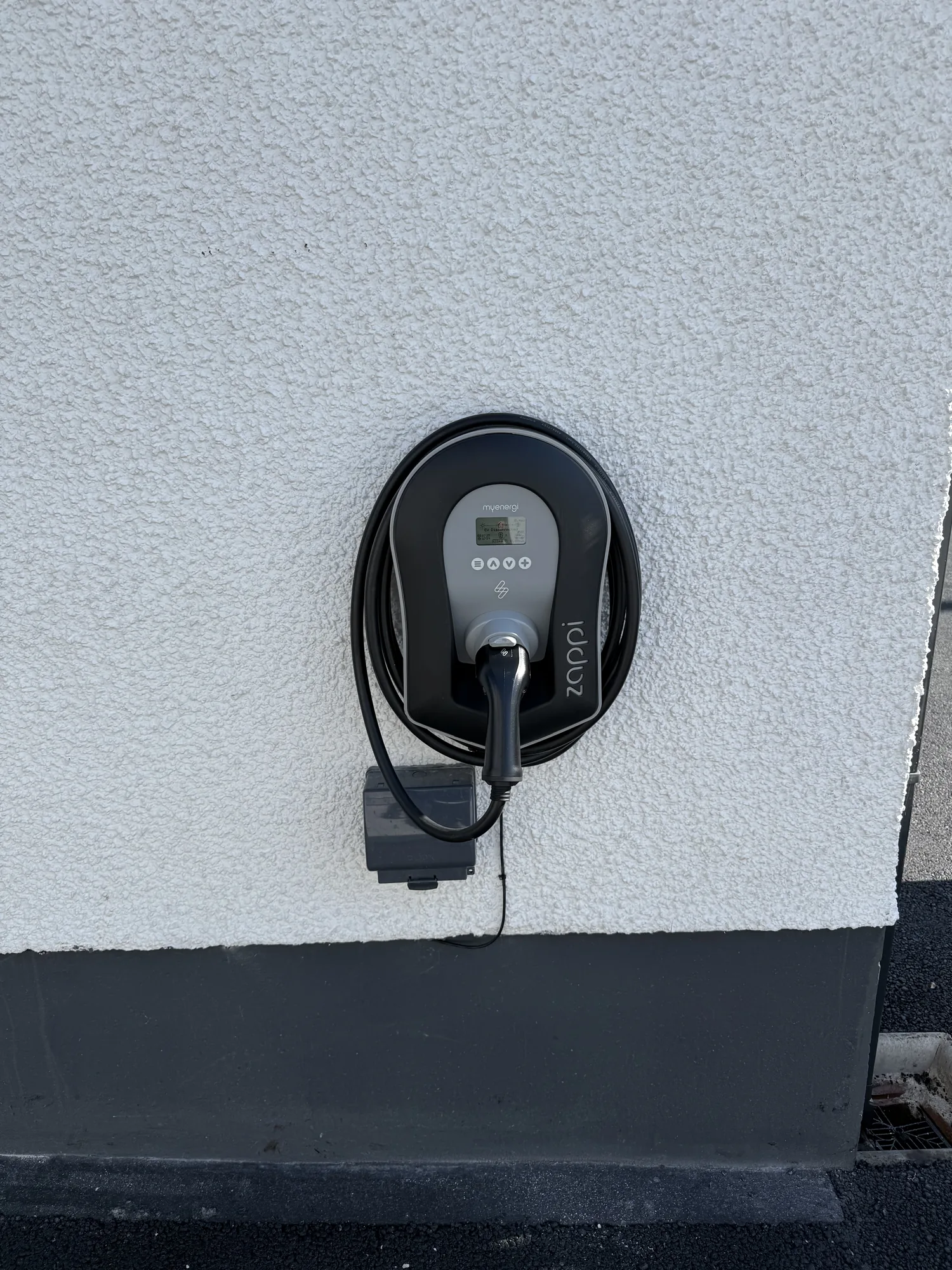 EV charge point fitted to an exterior wall